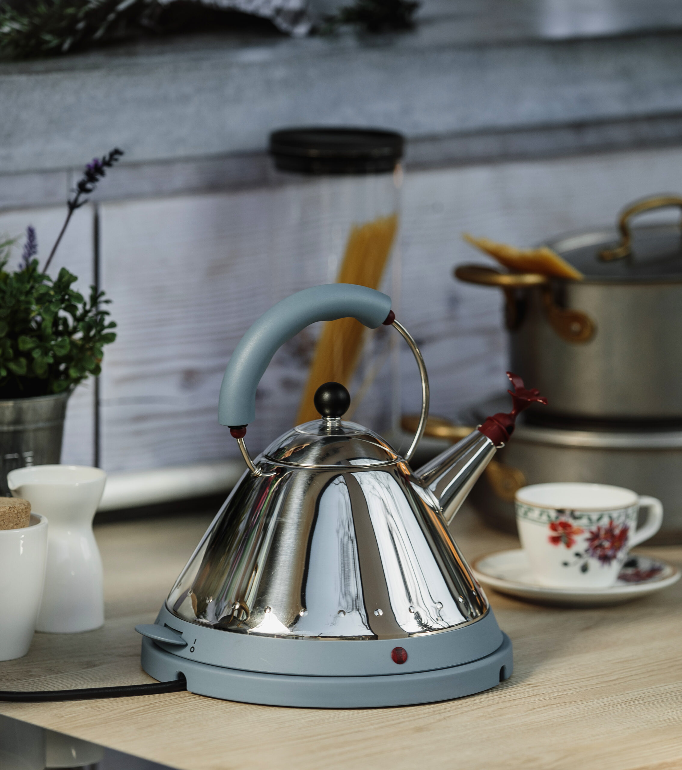 side view of electric modern kettle with whistle on a wooden table in kitchen side view of electric modern kettle with whistle on a wooden table in kitchen